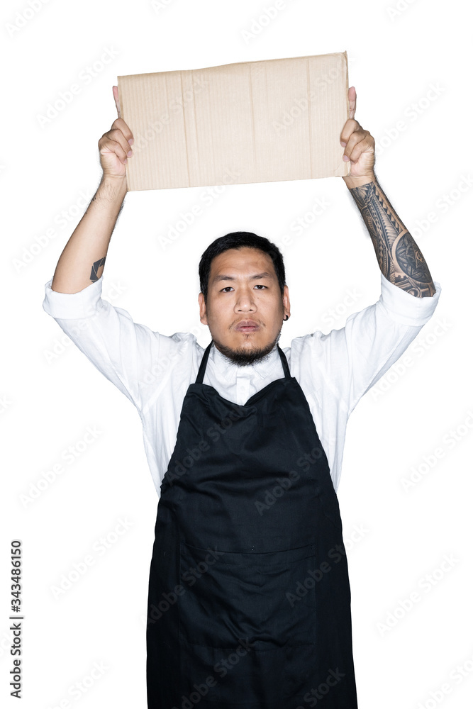 Bearded asian men waiter, chef dressed in black apron is holding cardboard in white background.The concept of protest, attention, request. Place for text or copy space. Clipping path. Bearded asian men waiter, chef dressed in black apron is holding cardboard in white background.The concept of protest, attention, request. Place for text or copy space. Clipping path.