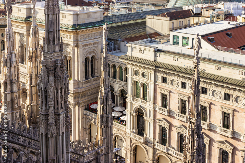 View from the decorated stone carvings of the Cathedral of Milan - Duomo di Milano roof in Milan city, Italy