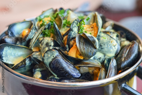 Mussels in a casserole with sauce curry