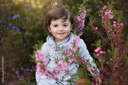 cute little girl outside on a spring sunny day with flowers