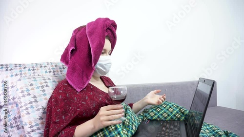 Girl in medical mask works in the comfort of home. Corona virus