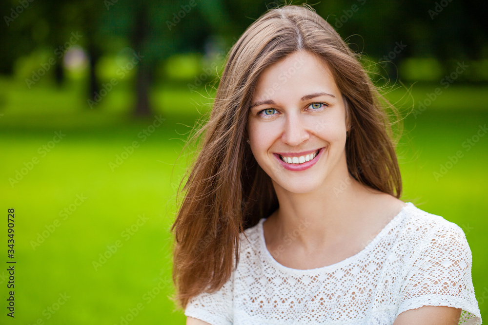 Close up portrait of beautiful young happy brunette woman with fresh and clean skin, summer street outdoors Close up portrait of beautiful young happy brunette woman with fresh and clean skin, summer street outdoors