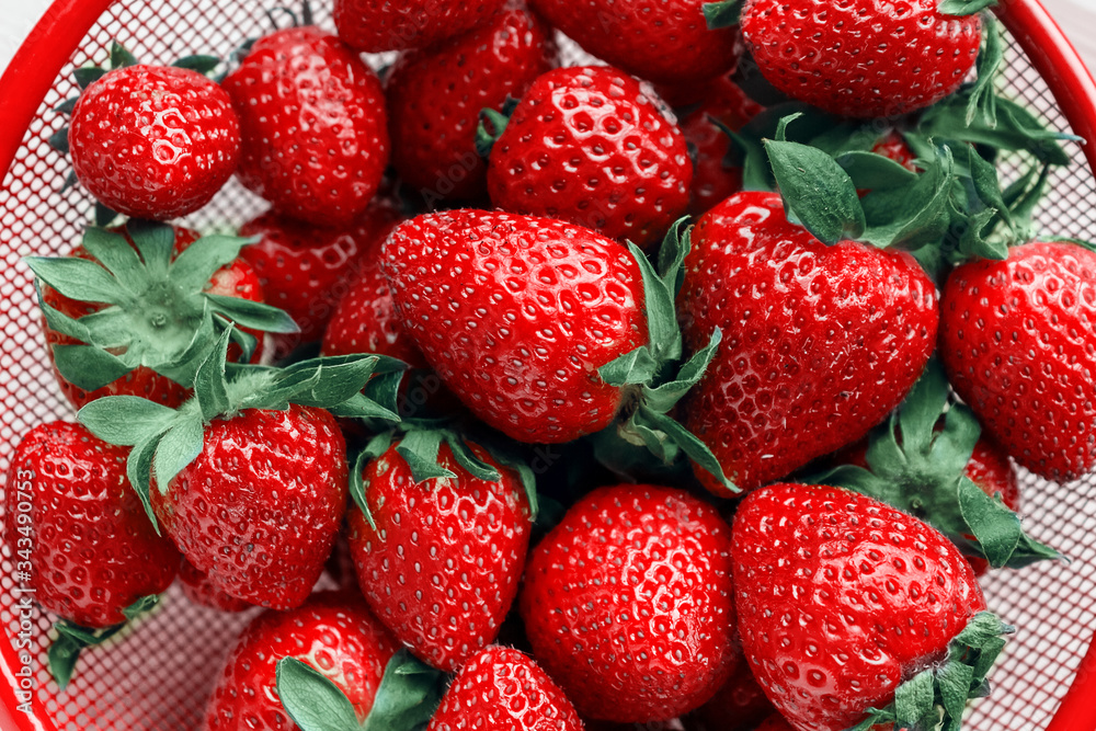 Fresh strawberries in red bowl. Close up. Fresh strawberries in red bowl. Close up.