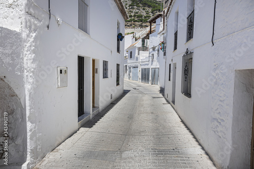 Beautiful view of Mijas Picturesque Narrow Street. Mijas - Spanish hill town overlooking the Costa del Sol, not far from Malaga. Mijas known for its whitewashed buildings. Mijas, Andalusia, Spain. © dbrnjhrj