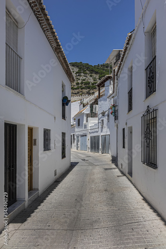 Beautiful view of Mijas Picturesque Narrow Street. Mijas - Spanish hill town overlooking the Costa del Sol, not far from Malaga. Mijas known for its whitewashed buildings. Mijas, Andalusia, Spain. © dbrnjhrj