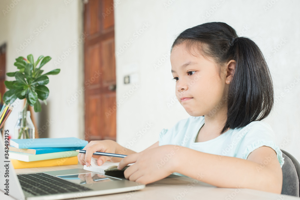 pretty stylish schoolgirl studying homework during online lesson at home, social distance during quarantine, self-isolation, online education concept, home school, study online video call teacher. pretty stylish schoolgirl studying homework during online lesson at home, social distance during quarantine, self-isolation, online education concept, home school, study online video call teacher.