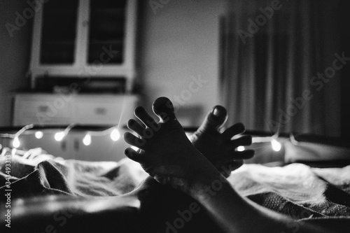 Two feet together in bed with lights