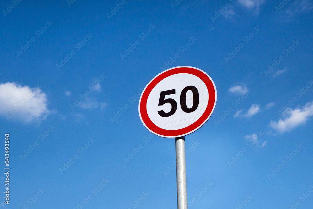 International traffic sign 'Speed limit' (to 50 km or miles per hour). Blue sky is on background International traffic sign 'Speed limit' (to 50 km or miles per hour). Blue sky is on background