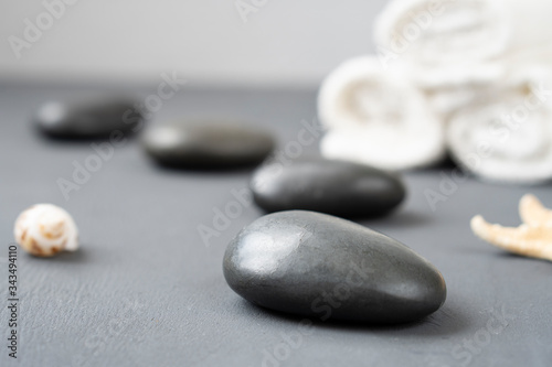 Set of Spa massage stones with seashells and starfish on a light background.  Concept of Spa rest and relaxation.