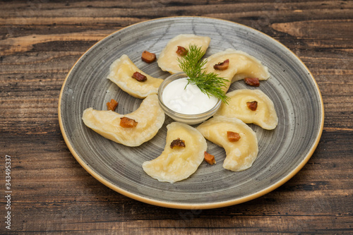 Dumplings with potato on wooden background
