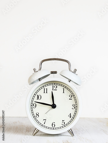 White alarm clock on table