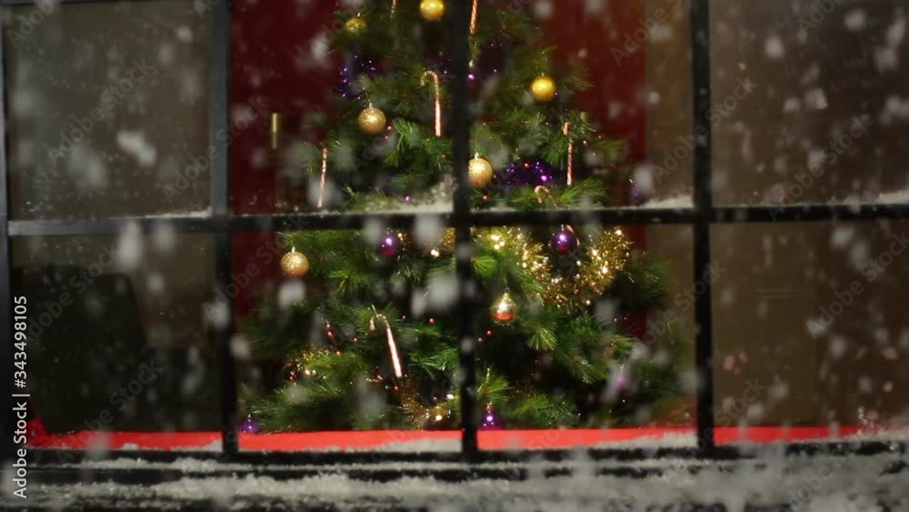 Christmas Tree in Window at a house with snow falling outside. Snowing. Stock Video Clip Footage