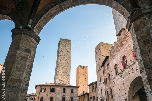 View of the famous towers from the historic center of the village of San Gimignano, a heritage of humanity, on a summer morning