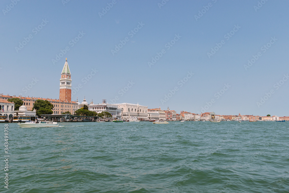 Street of Venice in summer time. Roof, sea canal in sunny day. Old city, ancient buildings. Popular tourist destination of Italy. Europe. Venetian canal without  people. Palazzo Ducale. Doge's Palace.