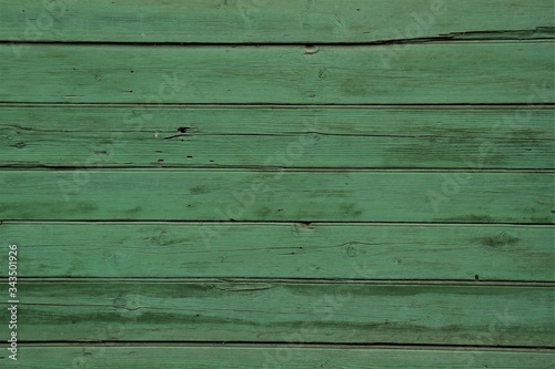 Wooden boards are painted with green paint.