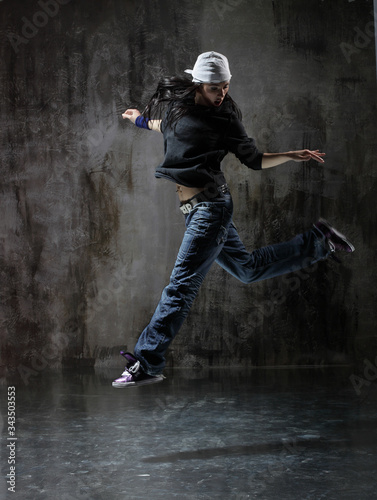 Young beautiful dancer is posing in studio