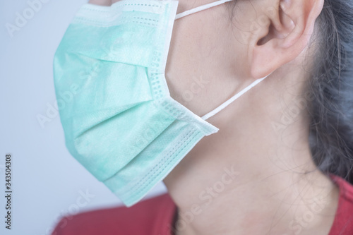 Closeup woman wearing hygiene protective mask to protect COVID19 virus face mask to protect corona virus crisis face of a woman wearing a mask that protects against the spread of virus disease