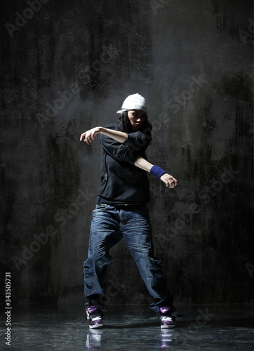 Young beautiful dancer is posing in studio