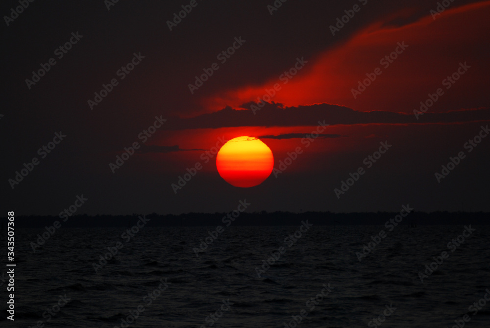 Tranquil scene of Closeup red sun and  red sky sunset over the ocean at Bangpu Thailand. Nature Background  and Beatiful detail 