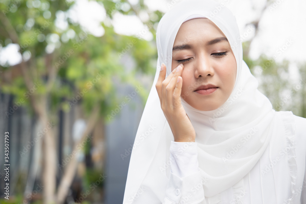 sick muslim woman or islamic woman suffering from eye disease, dry eye, red eye inflammation, allergy, optical fatigue, optical strain, vision impair sick muslim woman or islamic woman suffering from eye disease, dry eye, red eye inflammation, allergy, optical fatigue, optical strain, vision impair