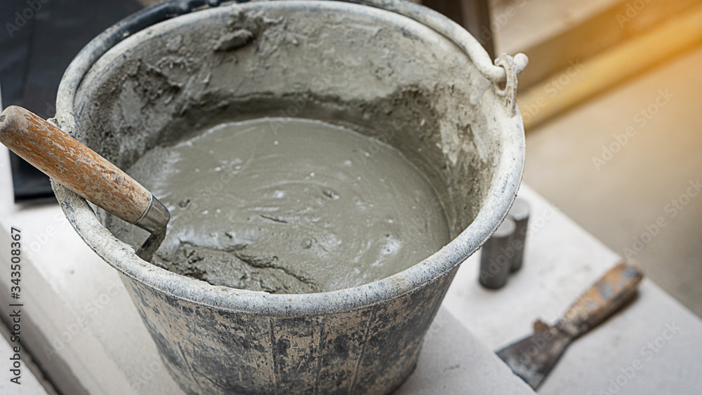 Mixing cement in the tank on the floor on the construction site Mixing cement in the tank on the floor on the construction site