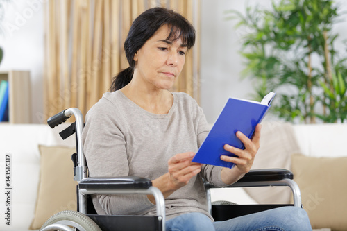 disabled woman in wheelchair with book