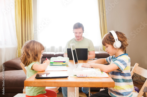 Two kids learn at home online. work from home with kids. quarantin. Home office. homeschooling, distant learning