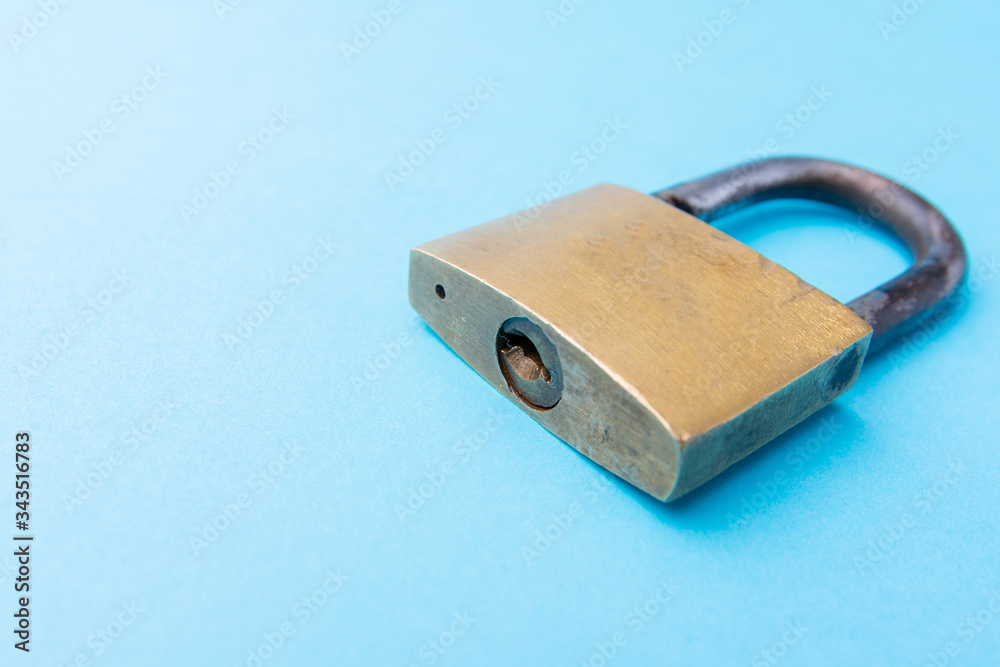 Old Padlock on a blue background. Copy space Old Padlock on a blue background. Copy space