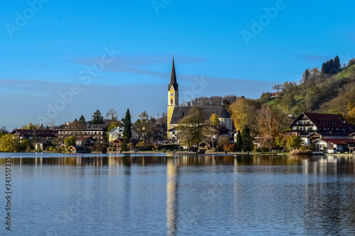 Tegernsee in autumn with church reflection on water of lake ath the Alps of Germany near Munich
