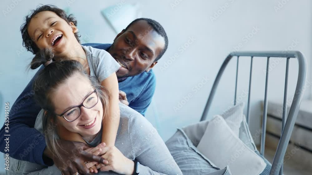 Happy young family, parents and baby son, mixed race