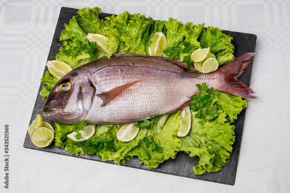 Fresh fish on an uncooked plate Fresh fish on an uncooked plate