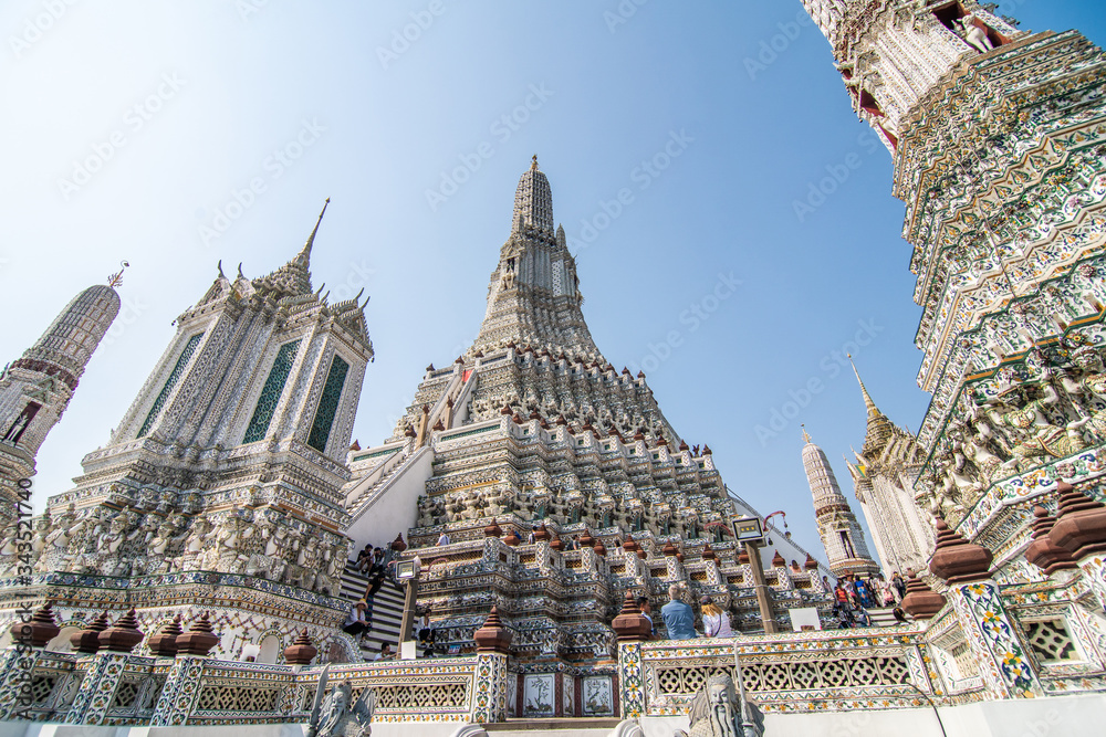 Bangkok, Thailand - January, 2020: The Temple of Dawn, Wat Arun, on the Chao Phraya river and a beautiful blue sky in Bangkok, Thailand. Horizontal with copy space