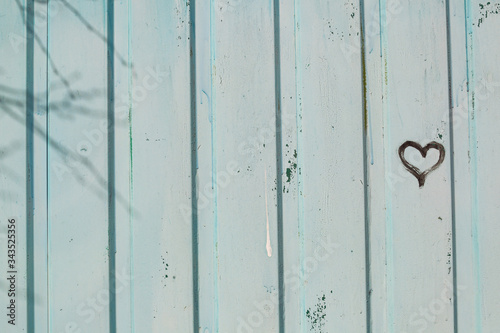 Drawing of a heart on a wooden fence.