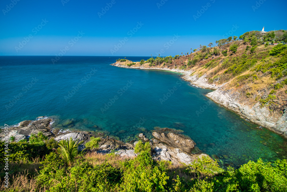 View of the rocky cliffs and clear sea under the bright sun. Promthep cape. Viewpoint in Phuket Thailand