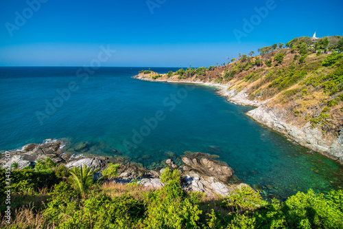 View of the rocky cliffs and clear sea under the bright sun. Promthep cape. Viewpoint in Phuket Thailand
