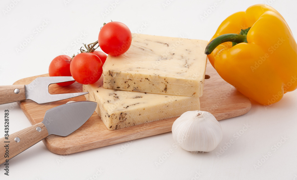 Yellow cheese, pieces on a white background, arranged with yellow pepper. Yellow cheese, pieces on a white background, arranged with yellow pepper.