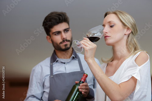 a beautiful woman tasting wine