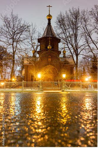 Russia Moscow. Night time. Old wooden russian church. Streets after rain, wet asphalt.