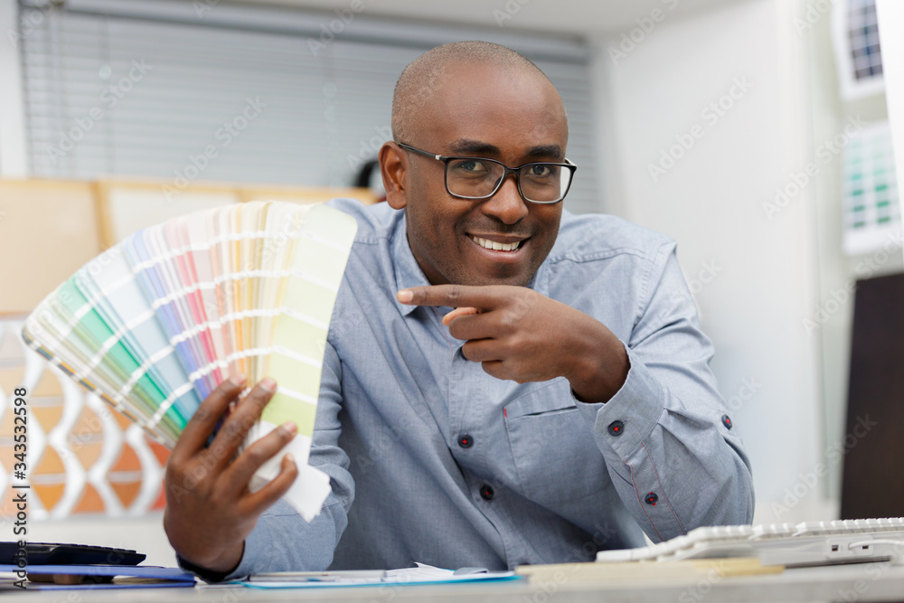 Fototapeta premium man picking a color for house walls