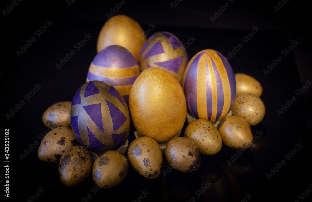 Fototapeta premium Purple golden Easter eggs on a black background
