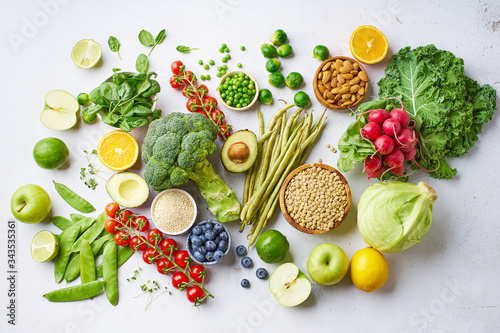 Assortment flat lay with healthy vegetarian meal ingredients. Raw food concept. A variety of organic fruits, nuts, berries and vegetables with avocado. Vegan menu.