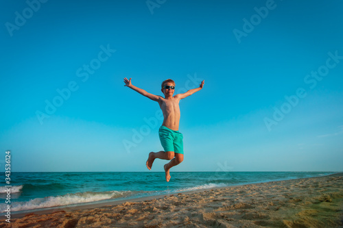 happy little boy play on beach, kid enjoy sea