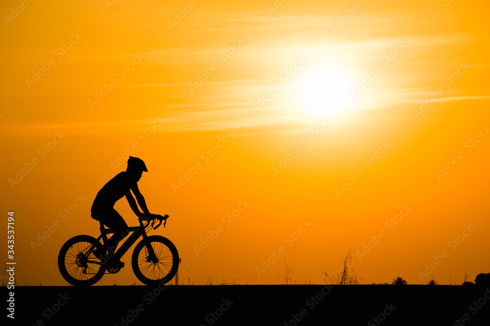 Silhouette man cycling on sunset background Silhouette man cycling on sunset background