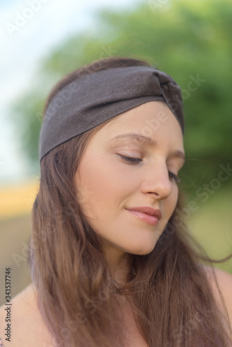 Portrait pretty woman in headband with long brunette hair © iwavephoto