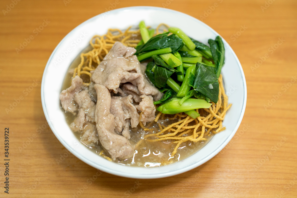 Crispy yellow noodles with pork and kale