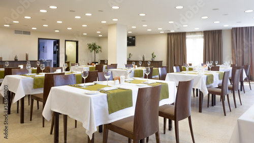 Restaurant interior in hotel. Brown and green design