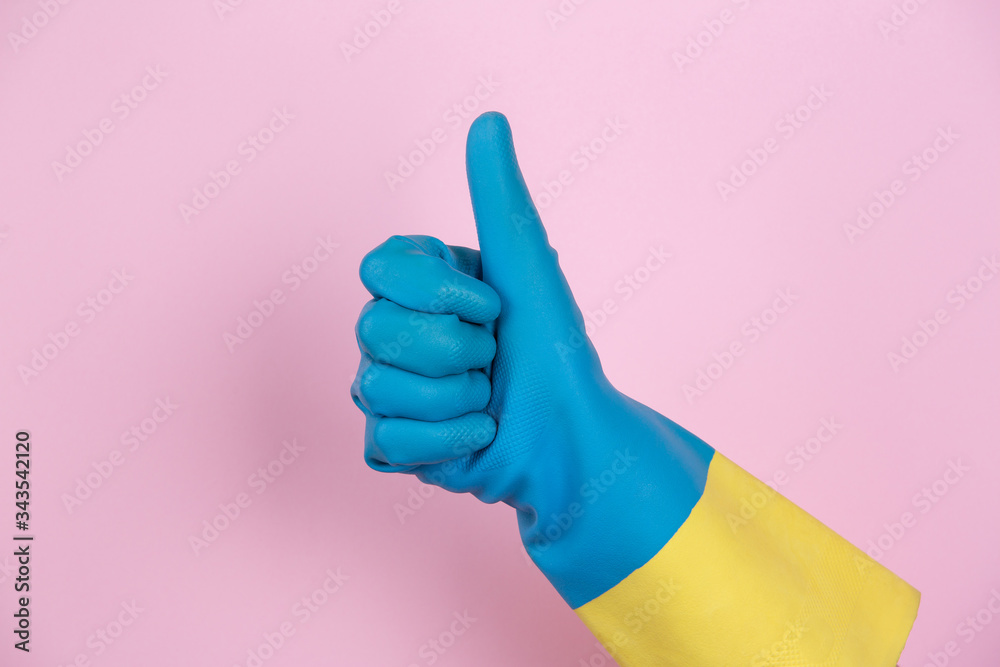 A hand with cleaning gloves making the OK gesture