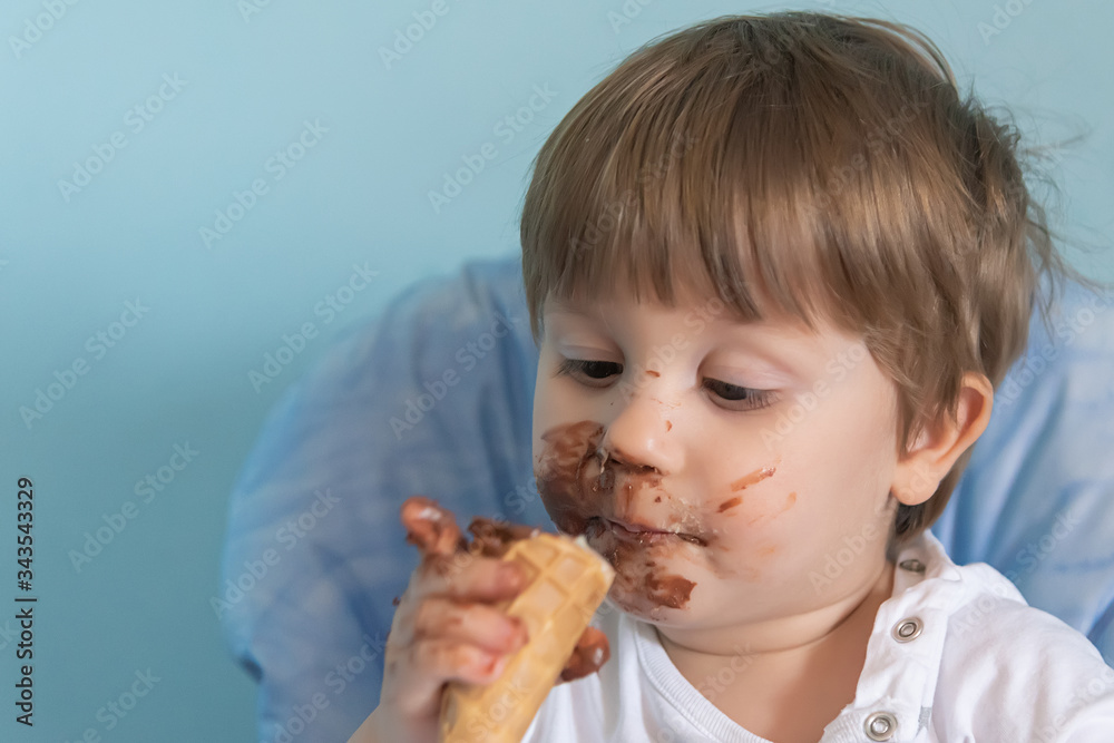 Little boy with chocolate ice cream smeared on face. Little boy eating ice cream Little boy with chocolate ice cream smeared on face. Little boy eating ice cream