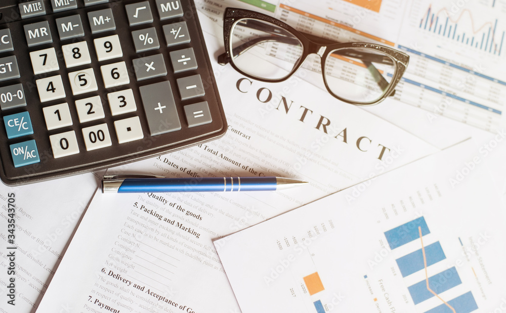 Business concept with calculator glasses and pencil on documents. Business grafs and charts. Contract Business concept with calculator glasses and pencil on documents. Business grafs and charts. Contract