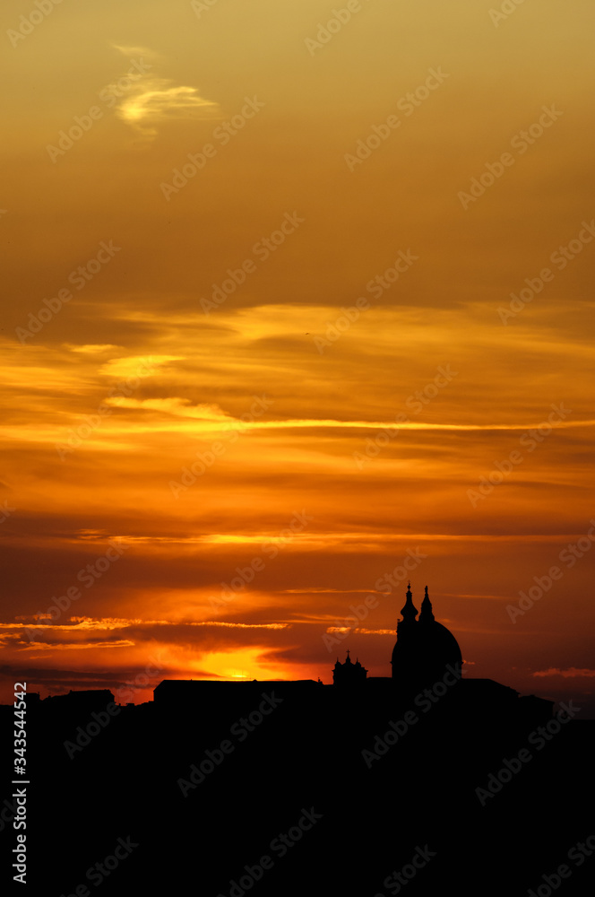 Sunset over the Basilica of the Holy House (Santa Casa) in Loreto (AN) Italy, silhouette of the skyline. Sunset over the Basilica of the Holy House (Santa Casa) in Loreto (AN) Italy, silhouette of the skyline.